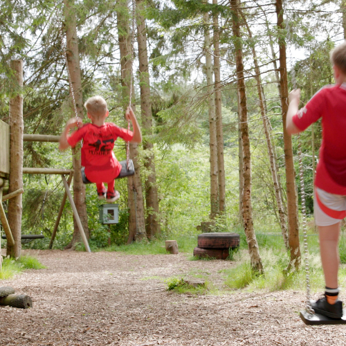 children playing on the swings is the cover of our 2025–26 Annual Report